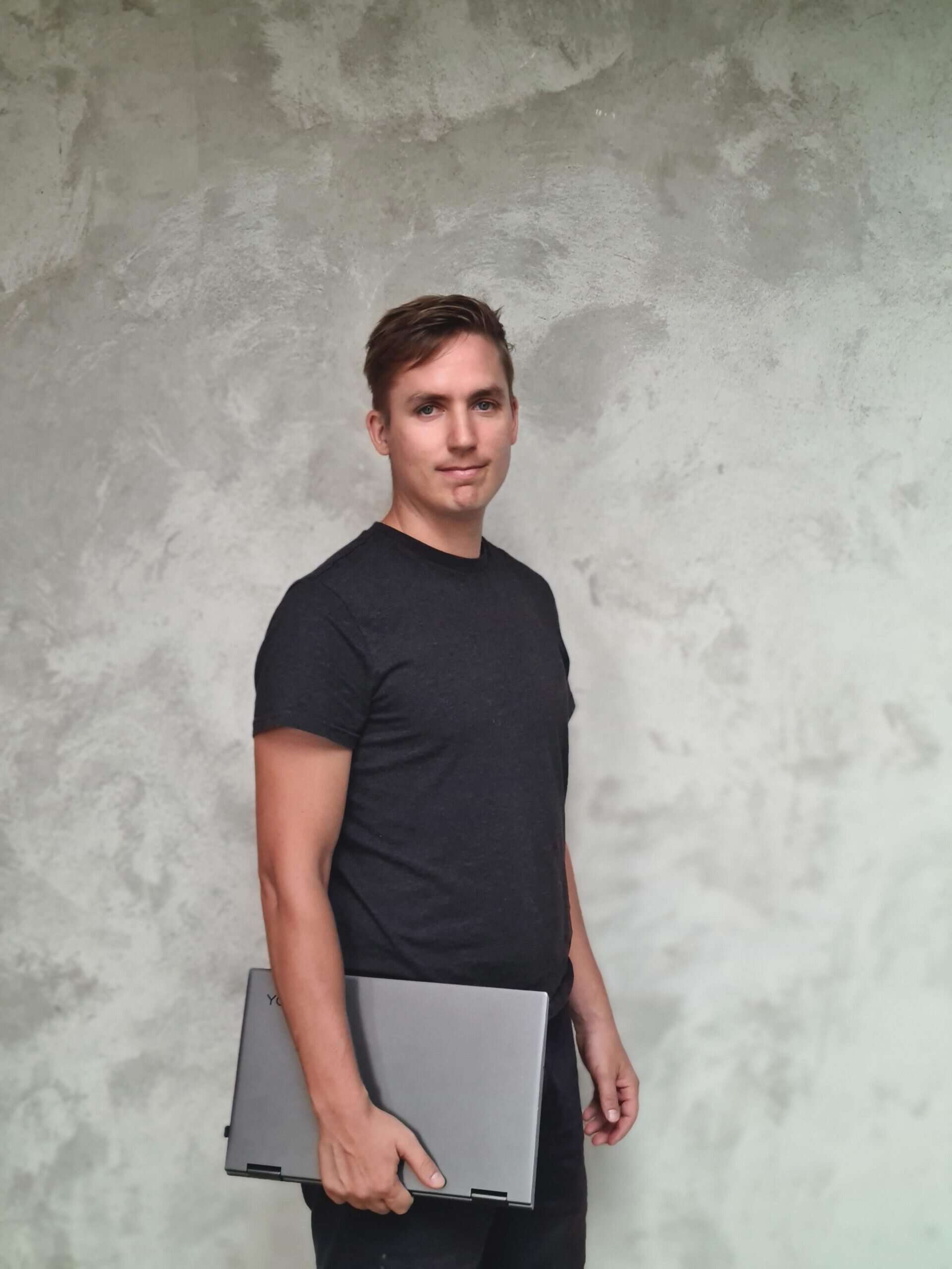 Kris, WordPress developer, holding a laptop